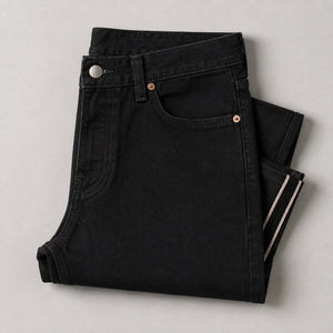 Black jeans folded, showing the waistband and pockets
