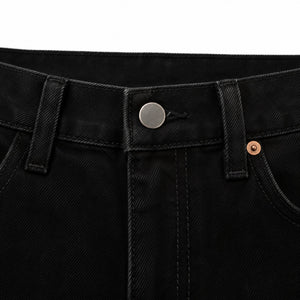 Waistband, button fly and copper rivet on the black jeans