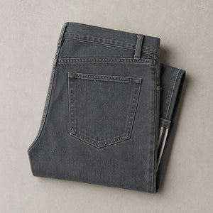 Washed grey jeans folded, showing the back pocket