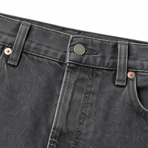 Waistband, button fly and copper rivet on the washed grey jeans